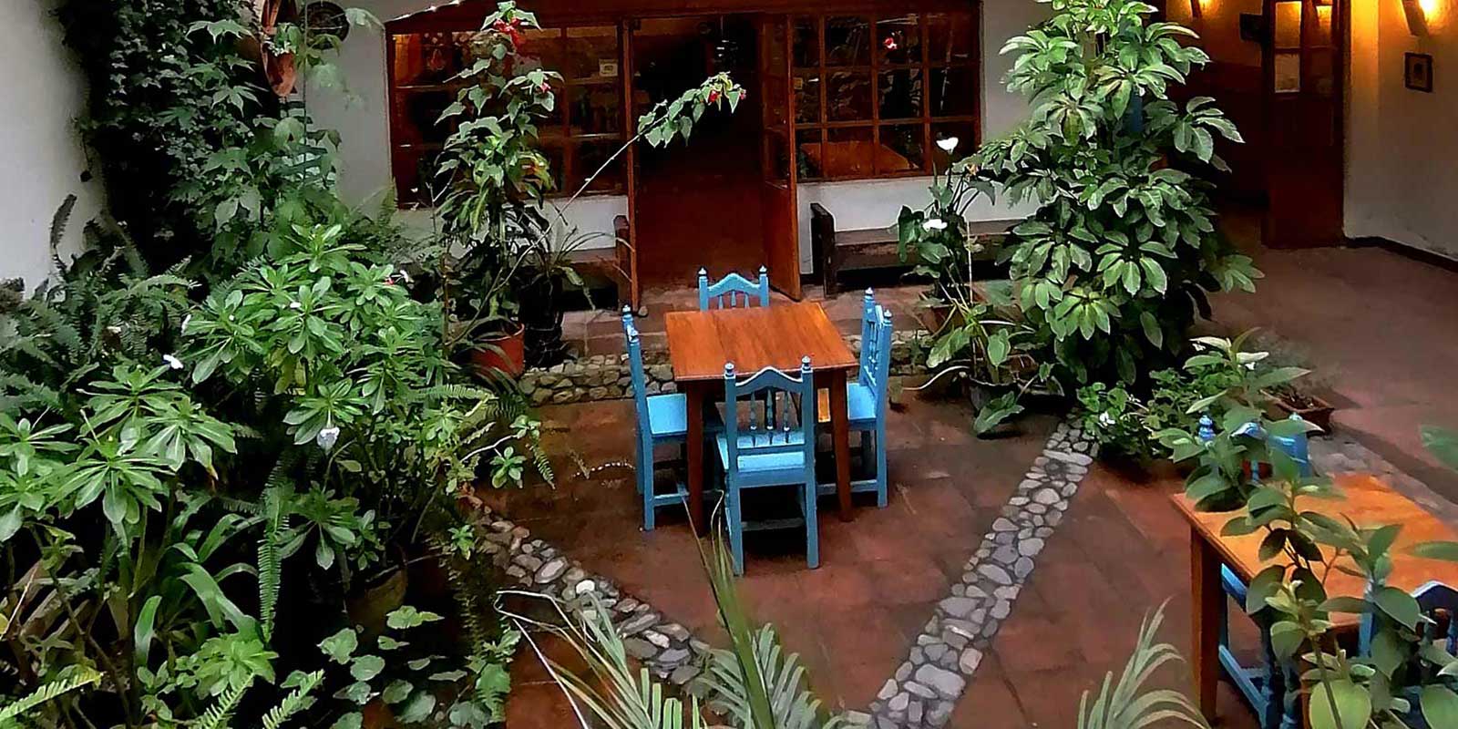 dinner table and chairs on an open air patio of hotel Doña Esther