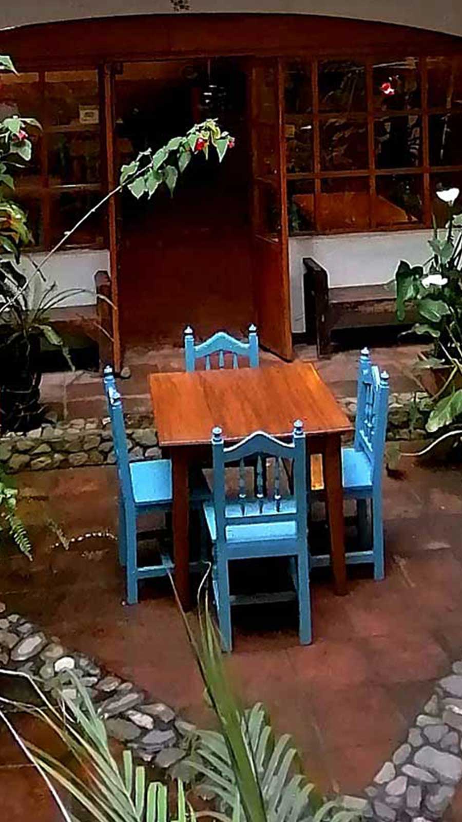 Dinner table and chairs on the patio of Hotel Doña Esther